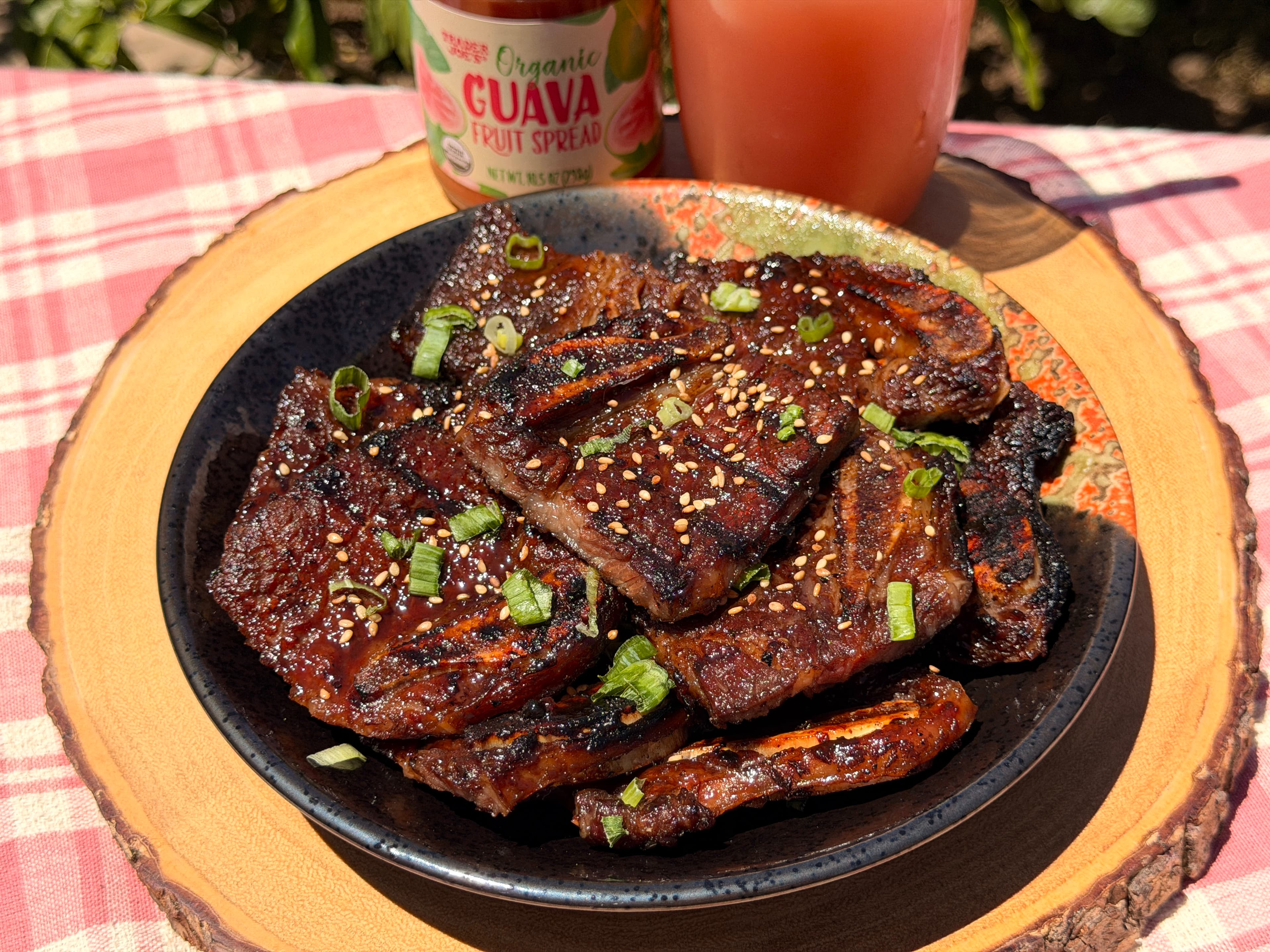 Grilled guava marinated short ribs glazed and topped with green onions and sesame seeds