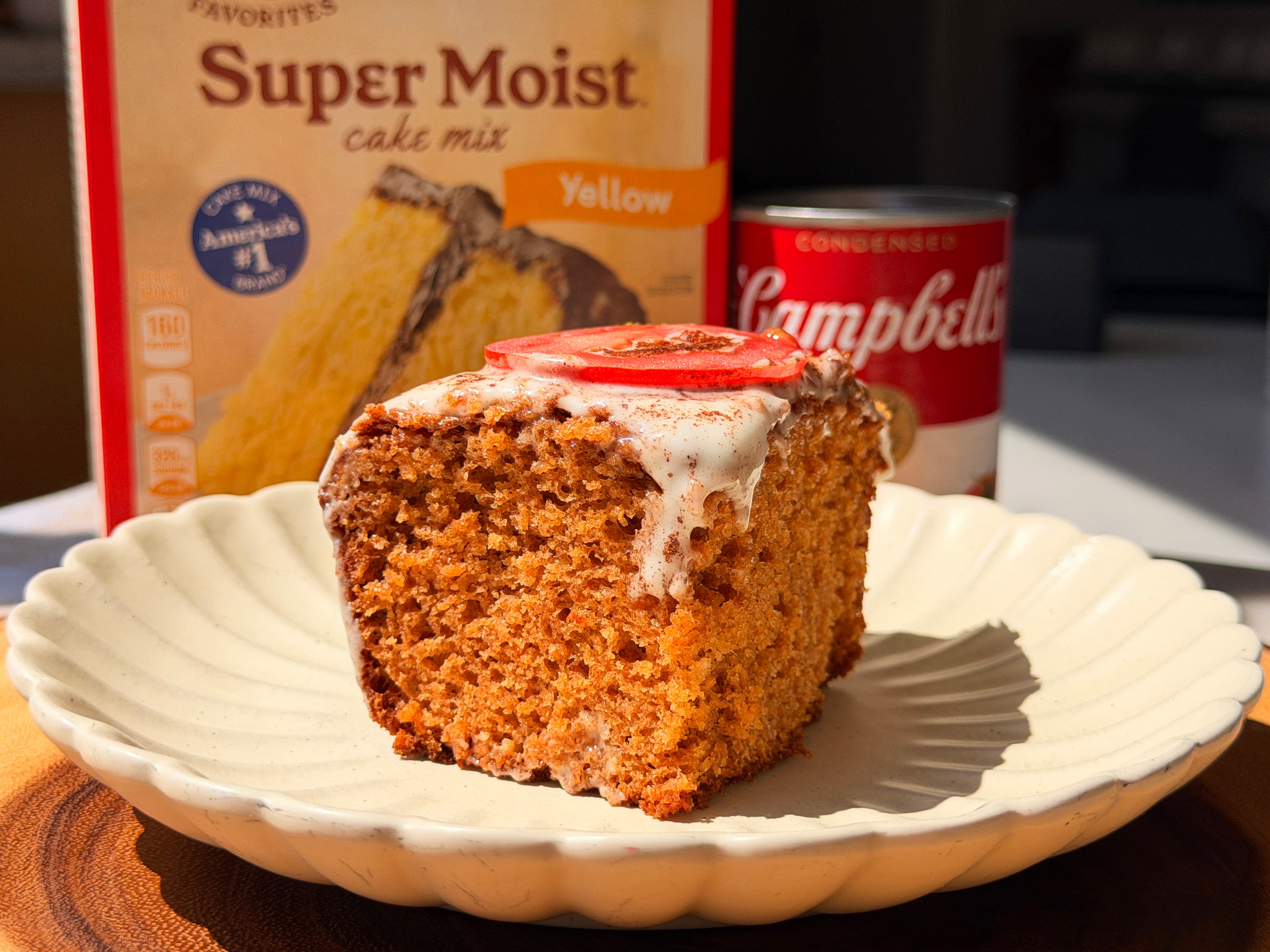 A slice of moist Tomato Soup Cake with cream cheese frosting