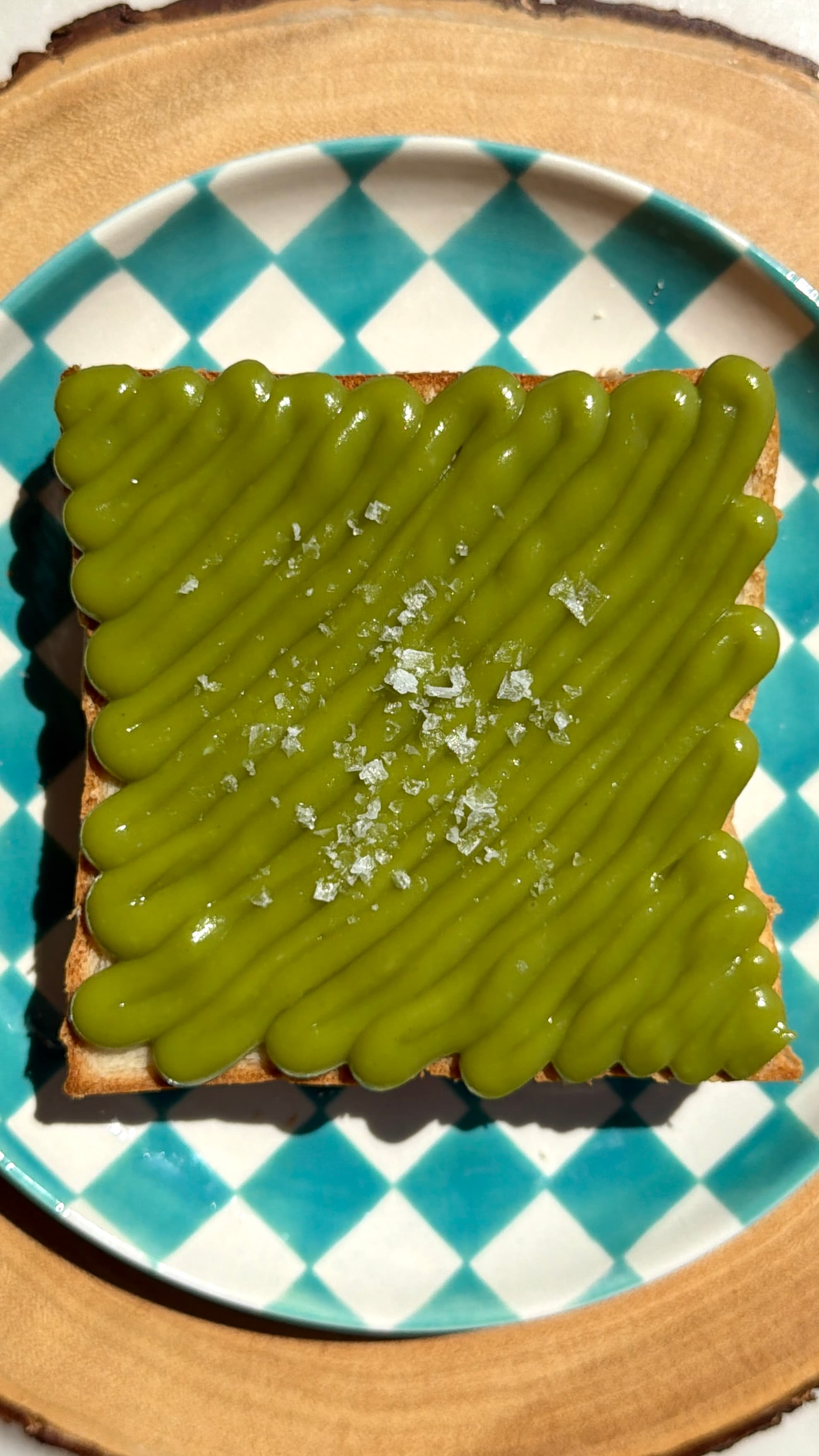 Thick slice of Japanese milk bread piped with bright green pandan kaya custard and finished with flaky salt