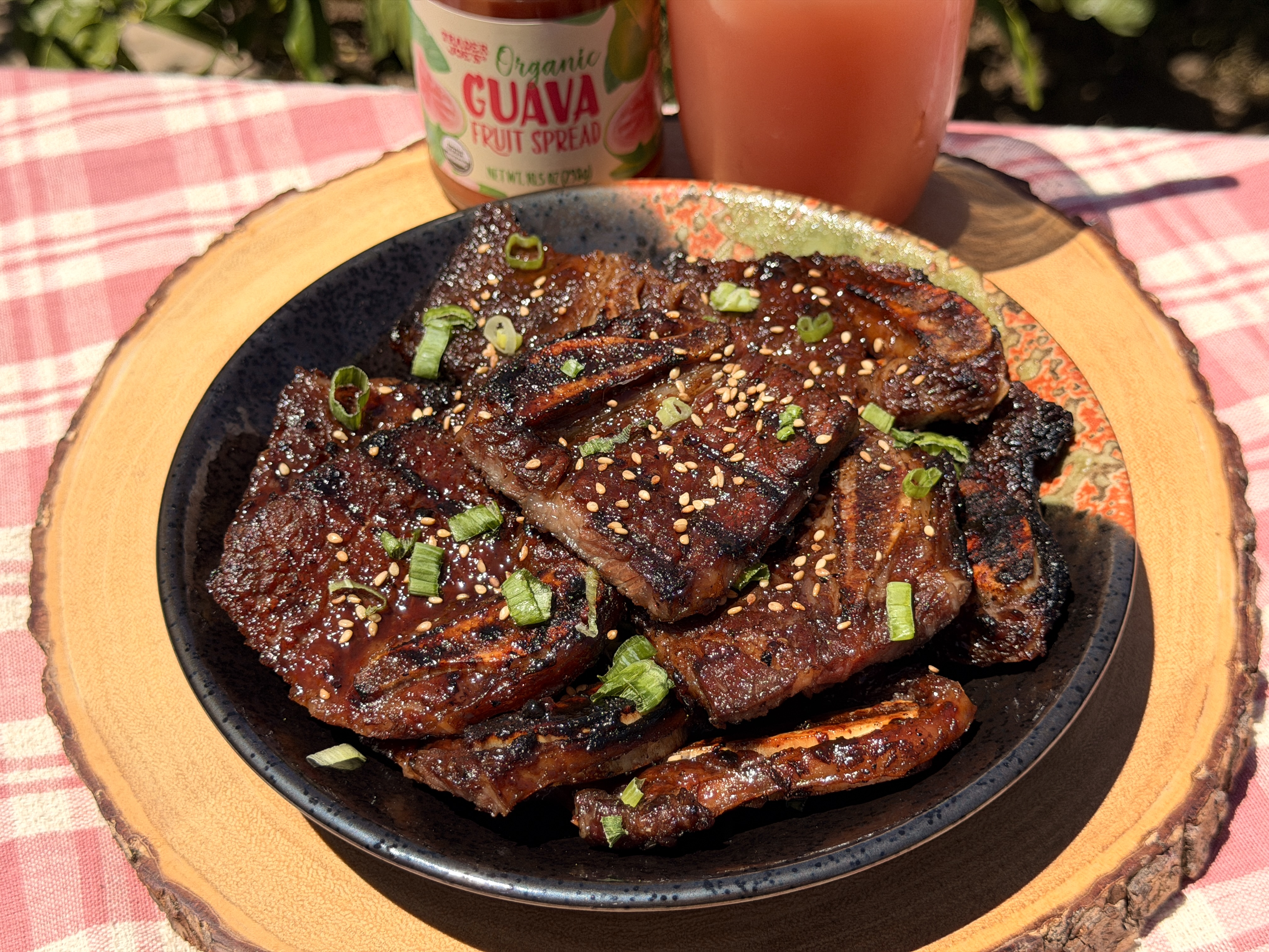 Grilled guava marinated short ribs glazed and topped with green onions and sesame seeds