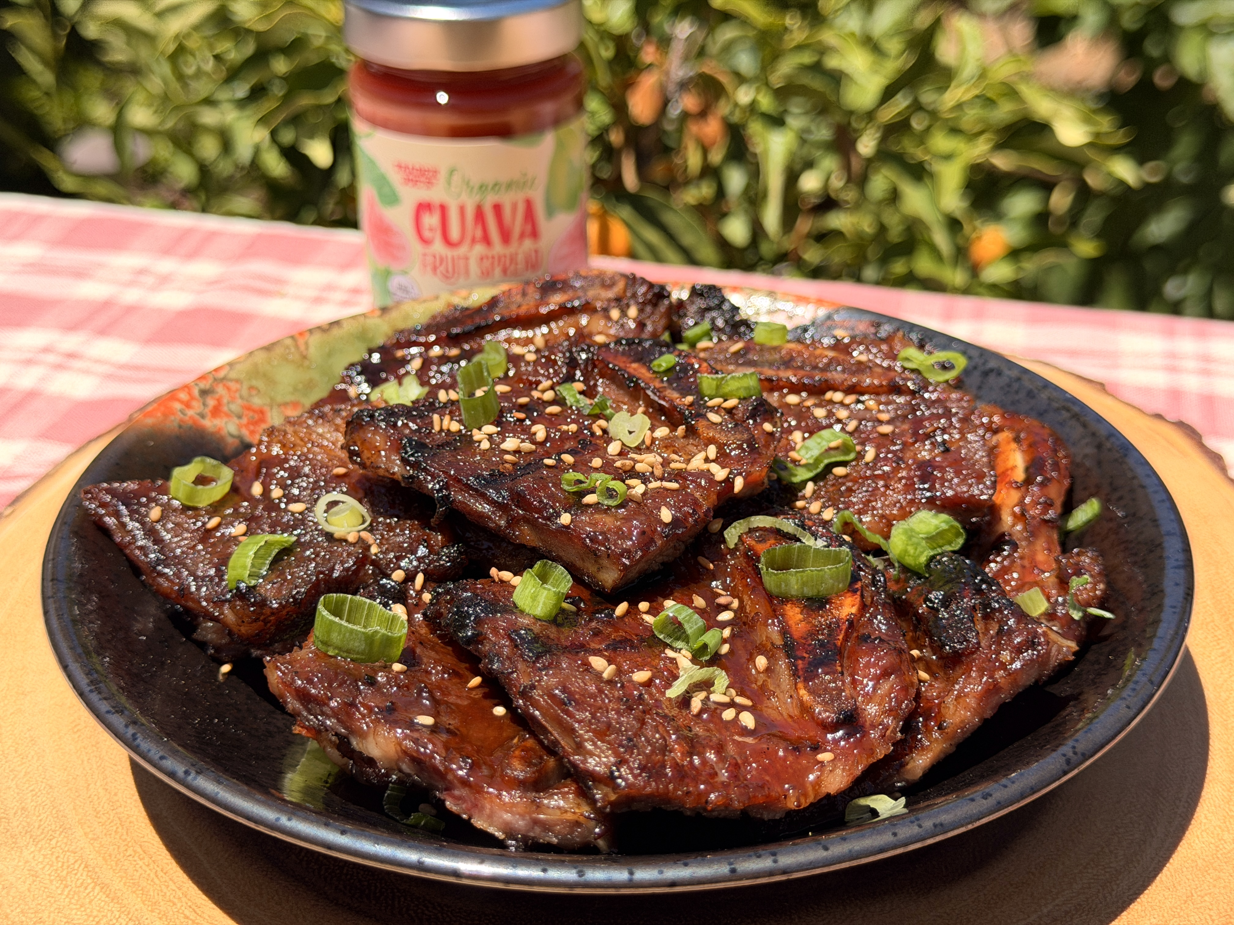 Glazed guava short ribs fresh off the grill, topped with green onions and sesame seeds