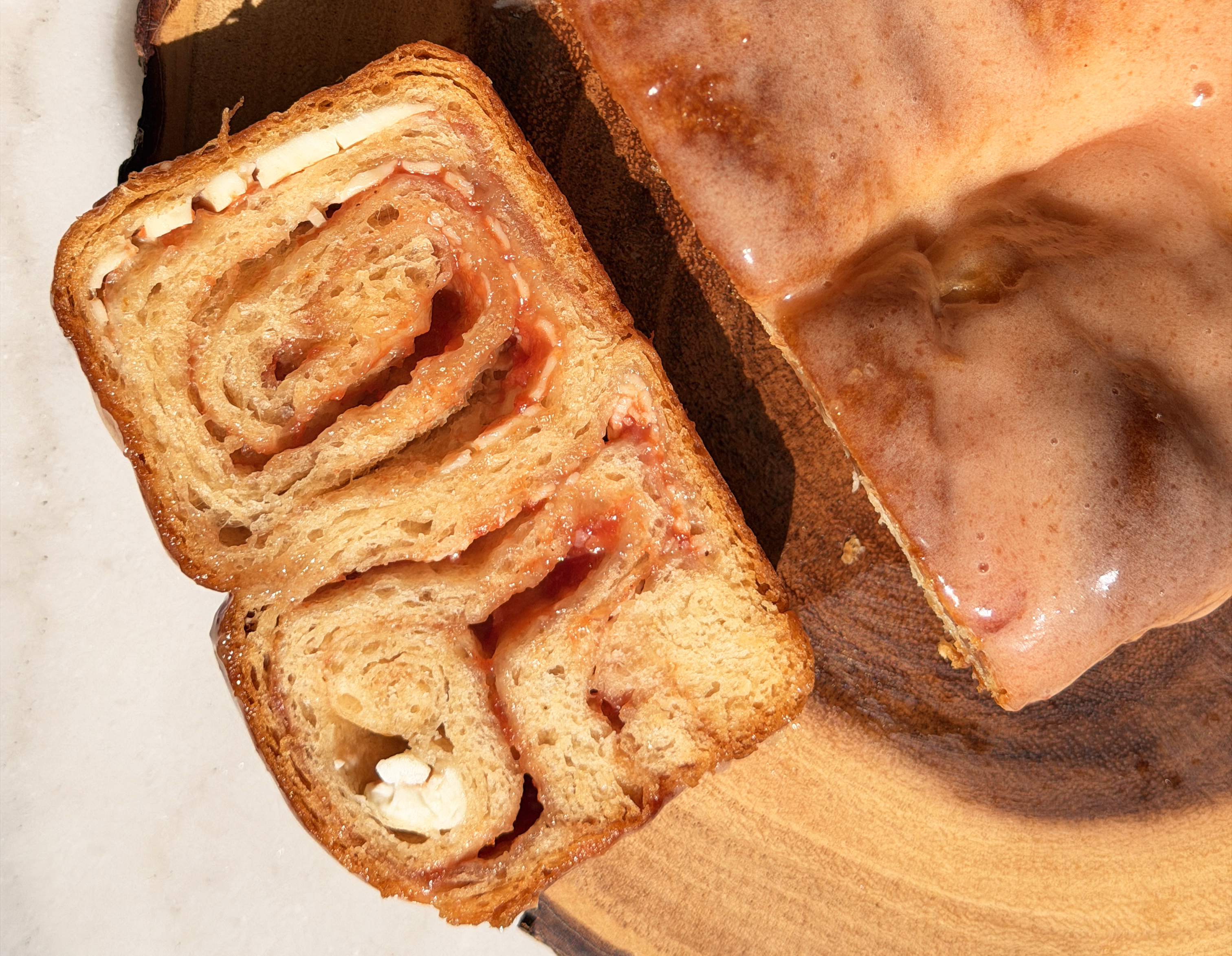Cross section of guava cream cheese crescent bread with visible layers of pink guava and cream cheese