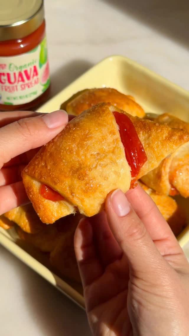 Golden brown guava cream cheese crescent rolls on a baking sheet