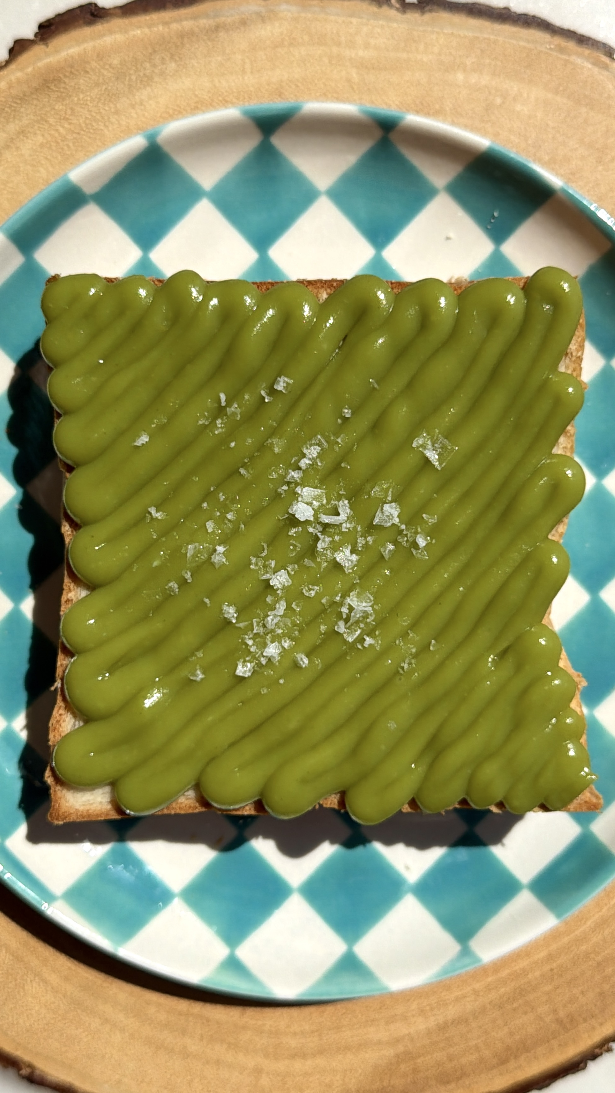 Thick slice of Japanese milk bread piped with bright green pandan kaya custard and finished with flaky salt